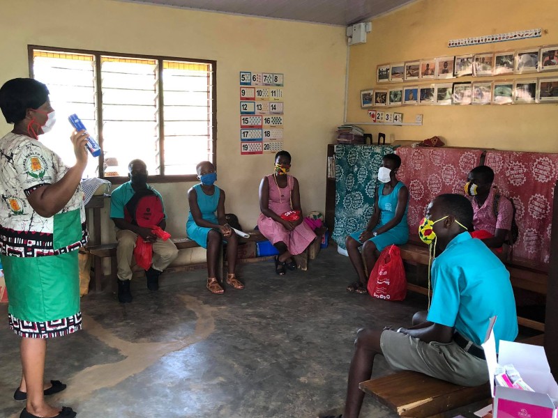 Older students gathered for a health information session wearing masks during Dekpor Health Week 2021