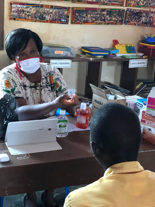 A student at Dekpor Basic School receiving medications during Health Week 2021