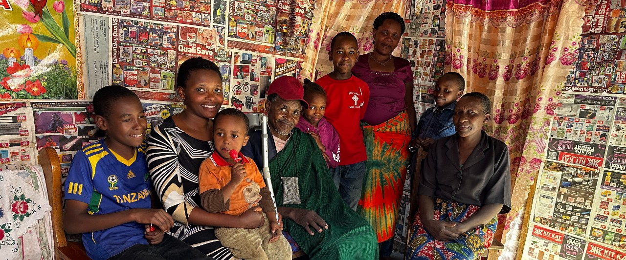 People in Tanzania smiling into the camera — a thank you from Tumaini Children's Foundation to Emajjin supporters