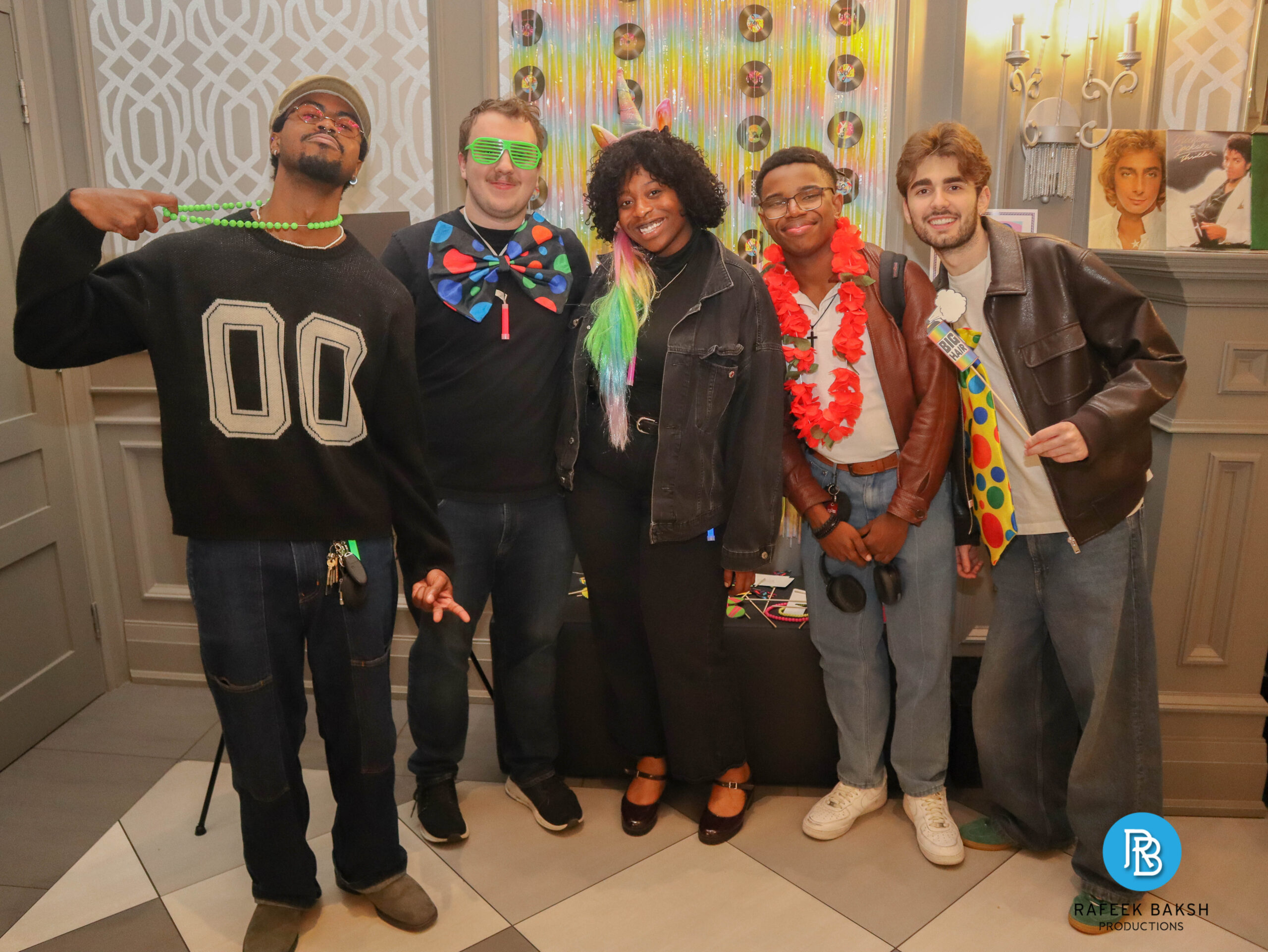 Shalom and Friends band posing at the photobooth wearing 80s gear and props at the 2025 gala