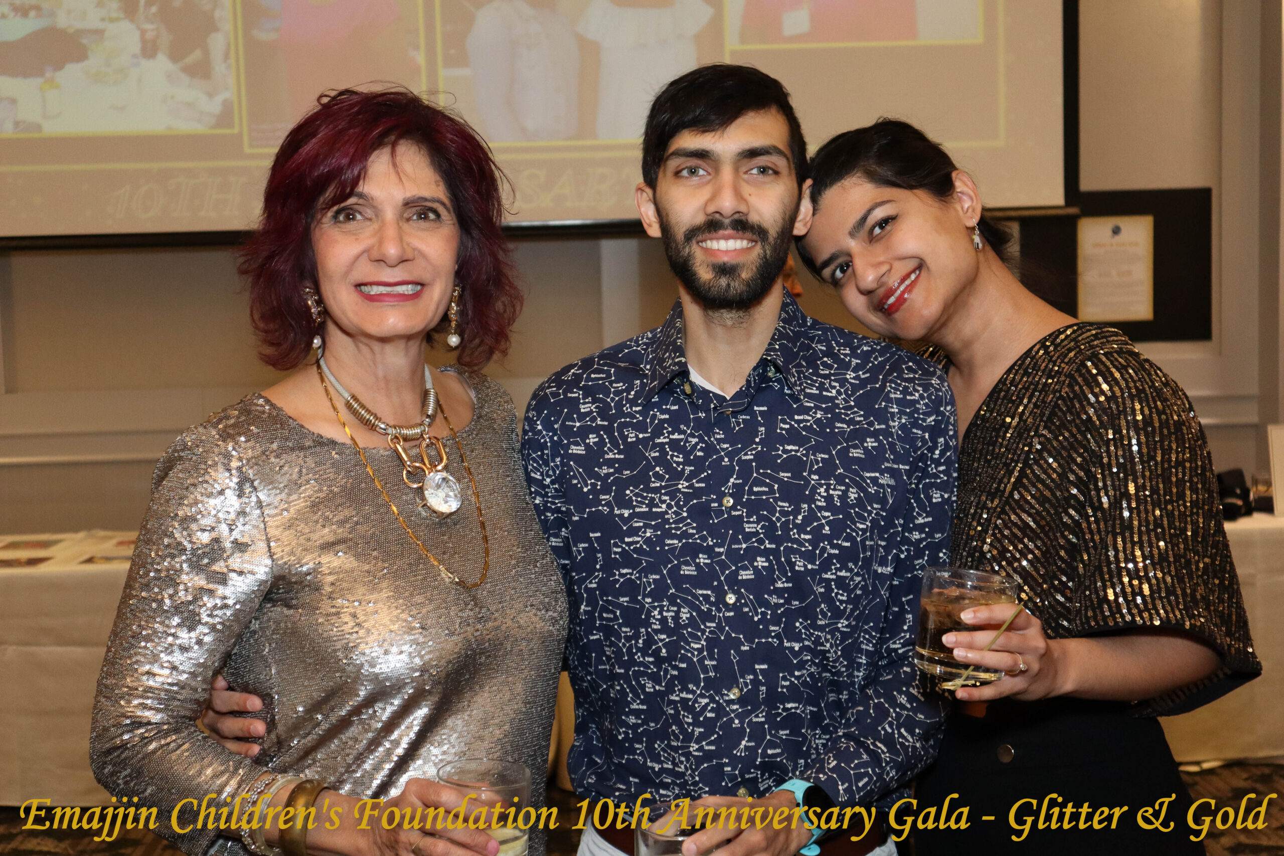 3 attendees of the Emajjin Gala standing beside each other smiling into the camera