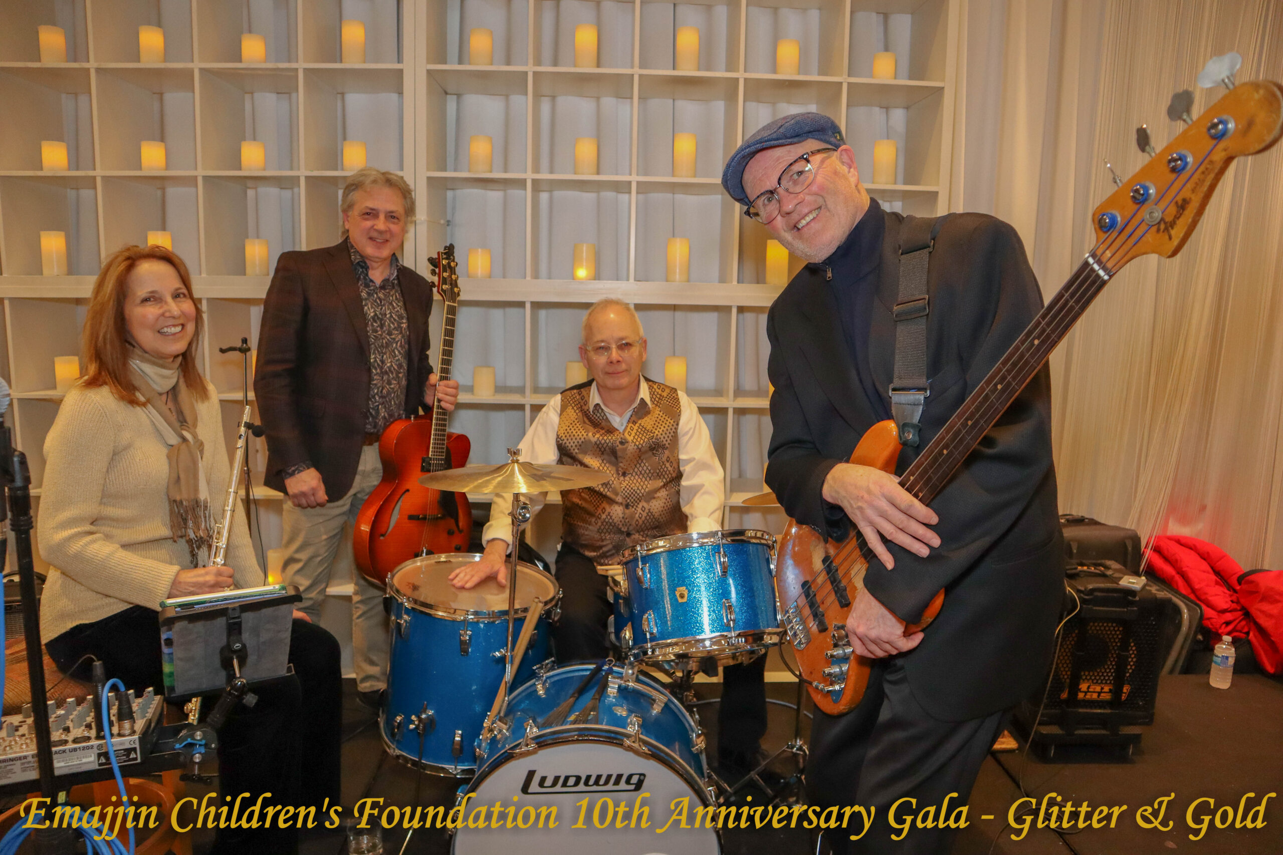 Northern Reflections Band posing for a photo on stage with their instruments.